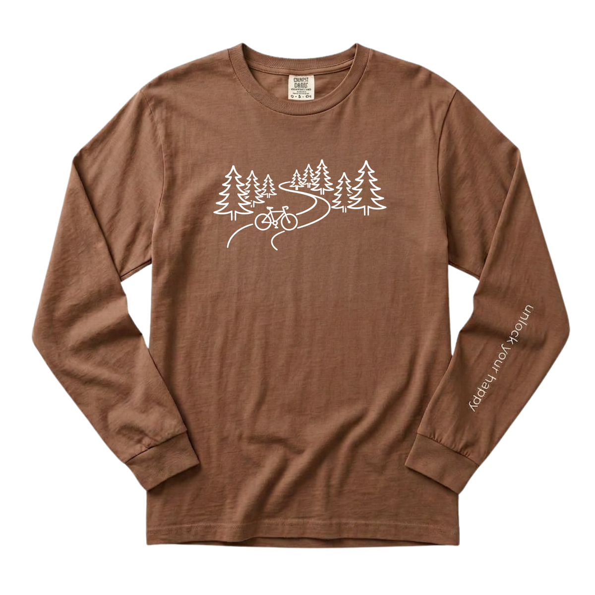 A long-sleeve crewneck t-shirt in a espresso brown color, featuring a white line art graphic of pine trees, a winding road, and a bicycle on the chest, with 'Unlock Your Happy' printed vertically in white on the left sleeve.