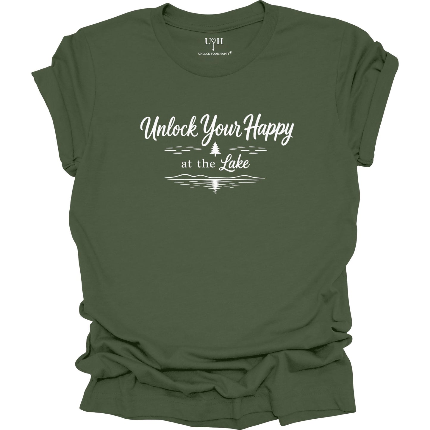 Green t-shirt with 'Unlock Your Happy at the Lake' text with a simple white line pine tree and lake wave on a white background
