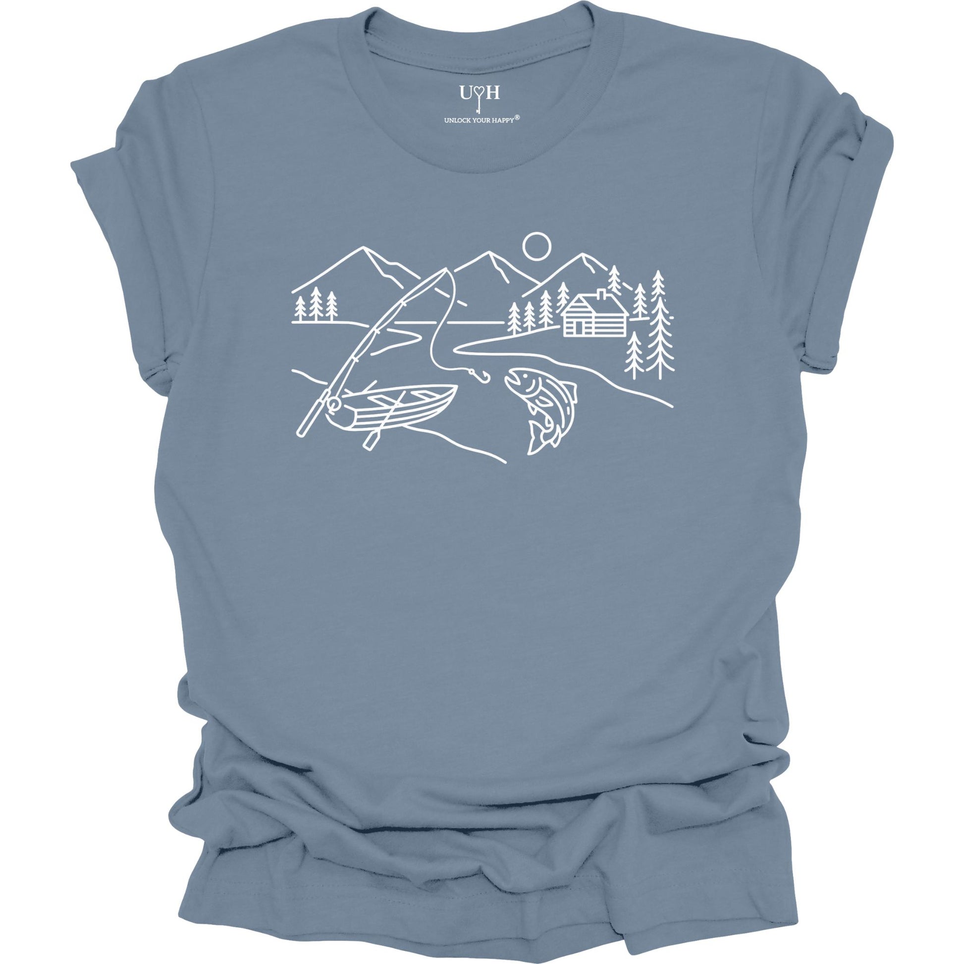 Blue t-shirt featuring a minimalist white line art fishing design with mountains, river, canoe, fish, cabin, and pine trees.
