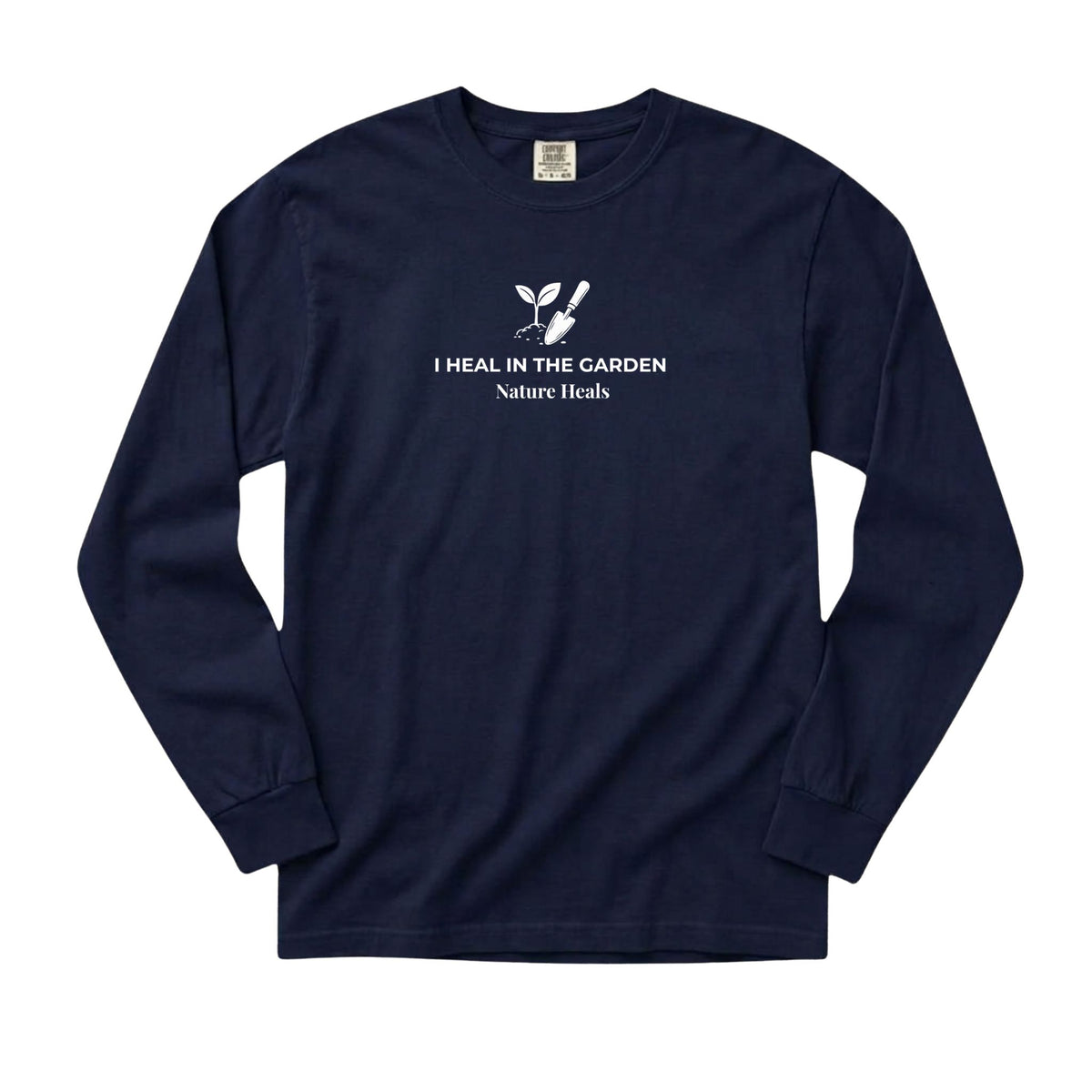 A navy-blue long-sleeve t-shirt with a white graphic on the chest showing a mound of soil, plant and trowel  and the text 'I HEAL IN THE GARDEN  Nature Heals'.