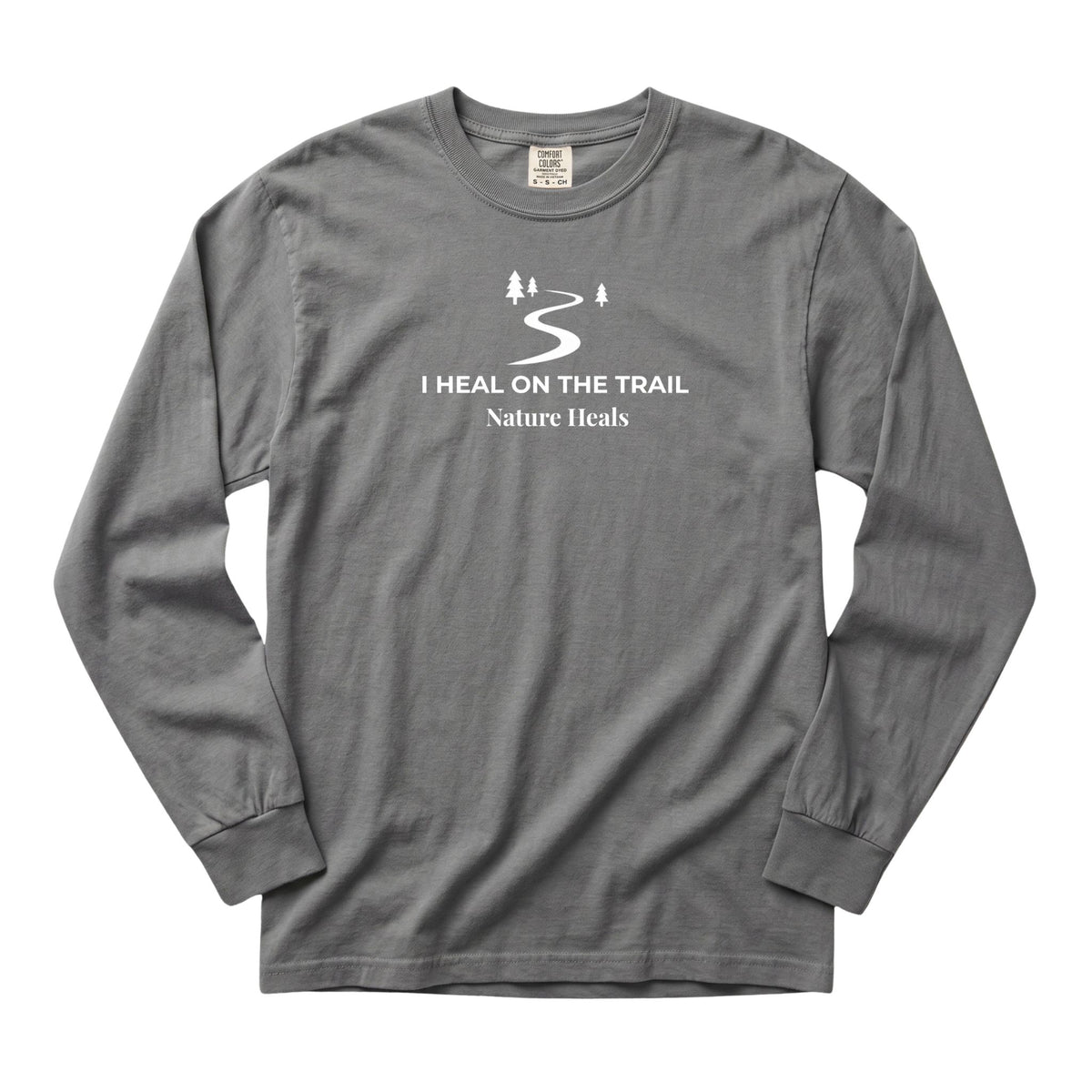 A  gray long-sleeve t-shirt with a white graphic on the chest depicting a winding trail and a few trees with the text 'I HEAL ON THE TRAIL Nature Heals'.