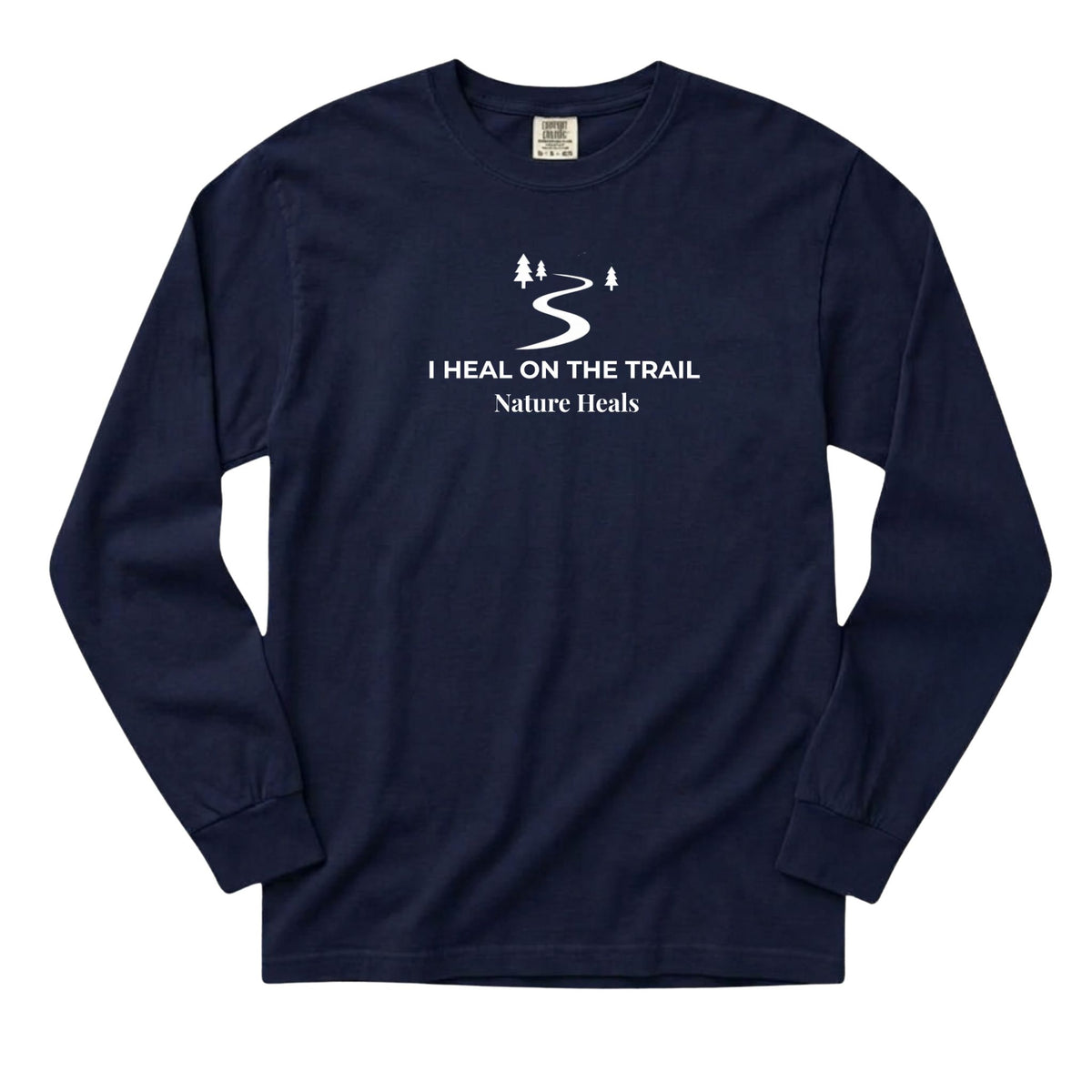 A navy blue long-sleeve t-shirt with a white graphic print on the chest that reads 'I HEAL ON THE TRAIL Nature Heals' with a winding trail and trees, displayed on a solid white background.