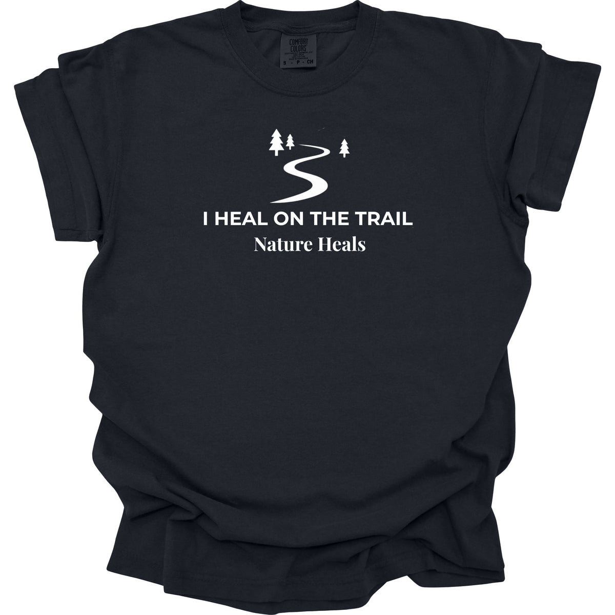 A black short-sleeve t-shirt with a white graphic print on the chest showing a winding trail between pine trees and the text 'I HEAL ON THE TRAIL Nature Heals'.