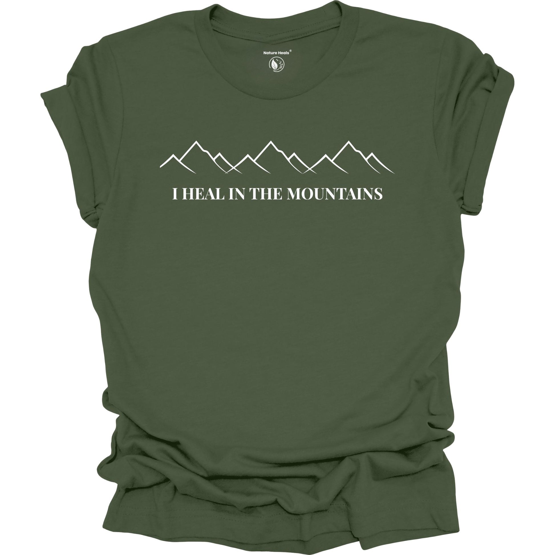 Green t-shirt with mountain graphic and text 'I Heal in the Mountains' on a white background