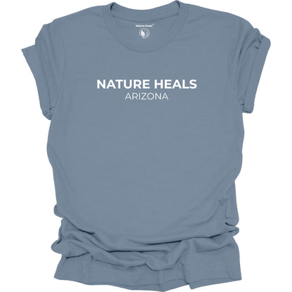 Blue t-shirt with 'Nature Heals Arizona' text on a white background