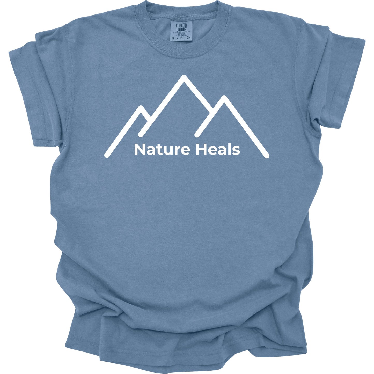 Blue t-shirt with white mountain graphic and 'Nature Heals' text on a white background