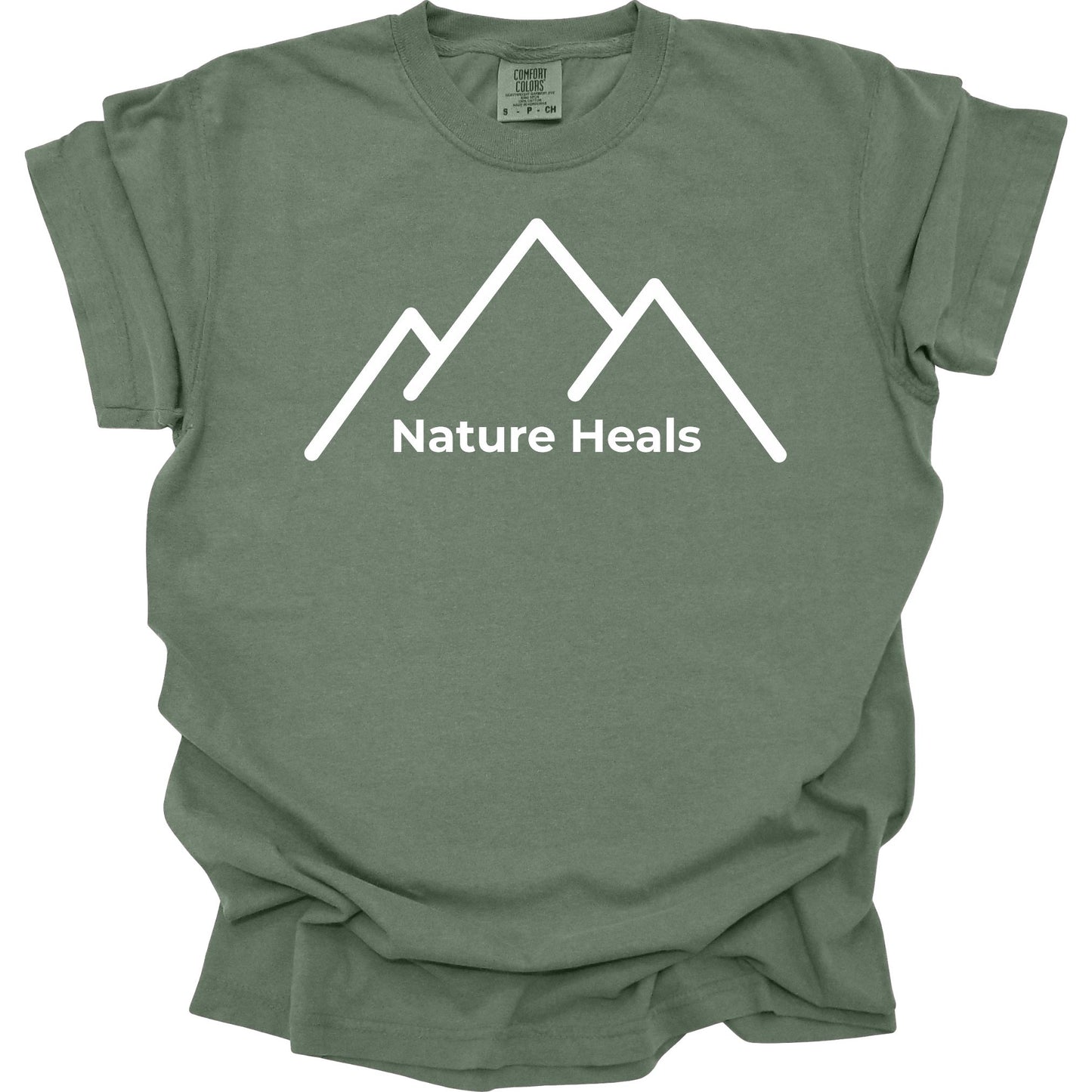 Green t-shirt with white mountain graphic and 'Nature Heals' text on a white background