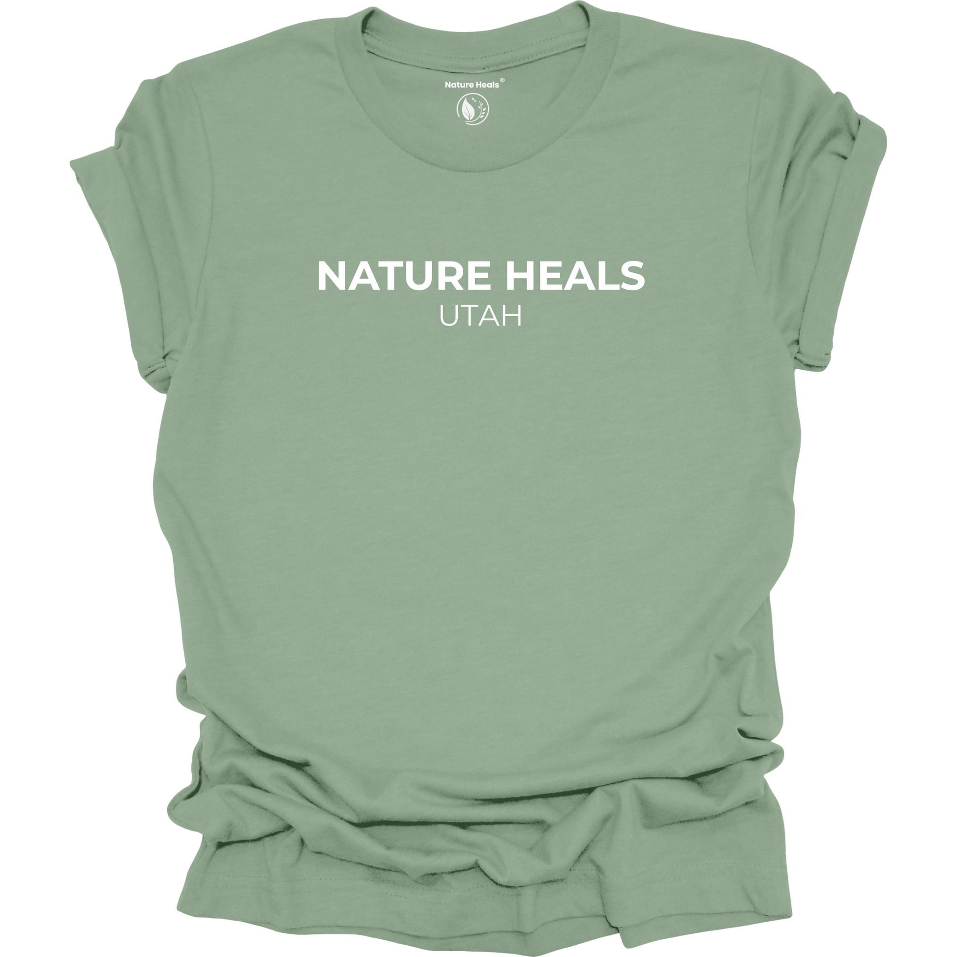 Sage green t-shirt with 'Nature Heals Utah' text on a white background