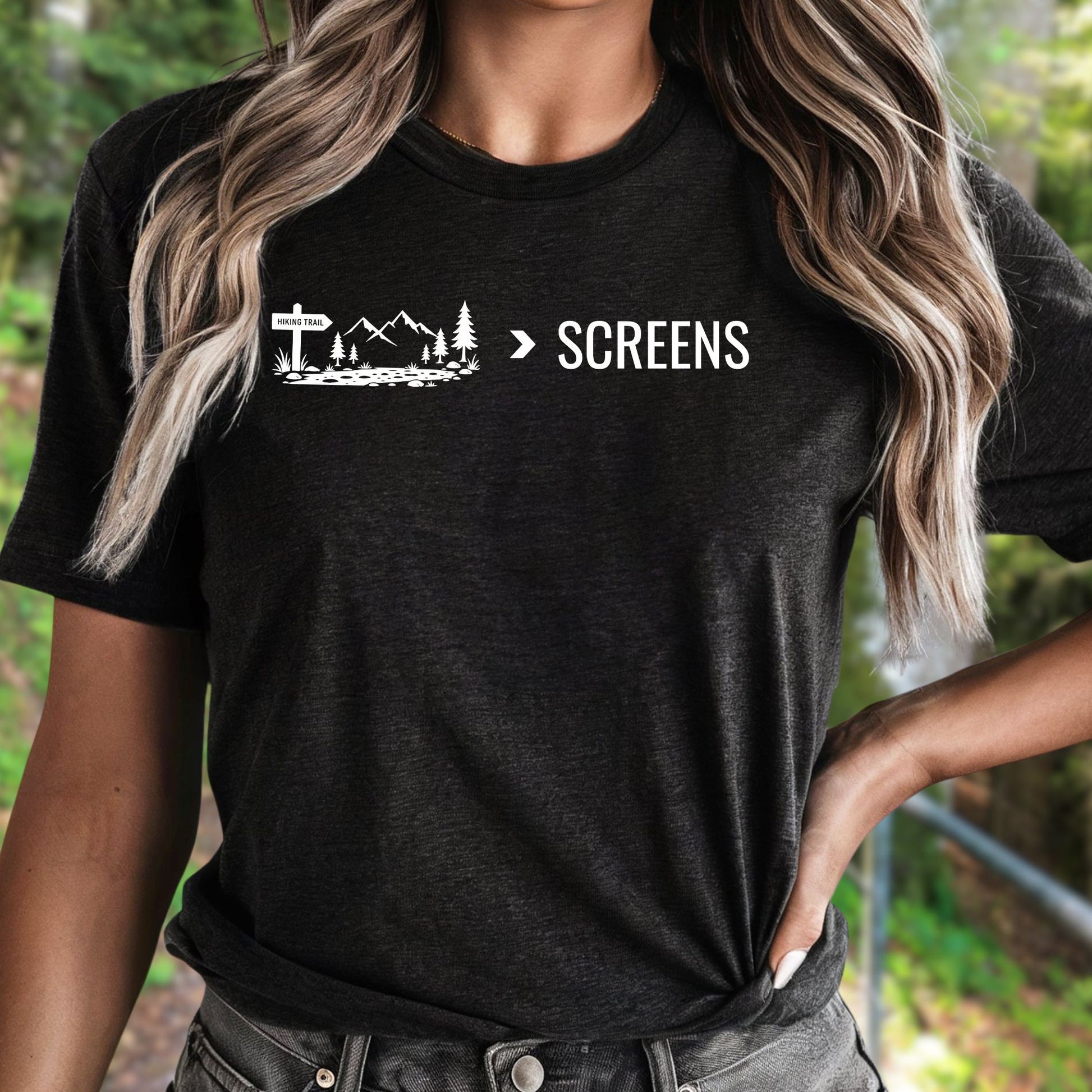 Female wearing a Nature Over Screens black t-shirt featuring mountains and trees 