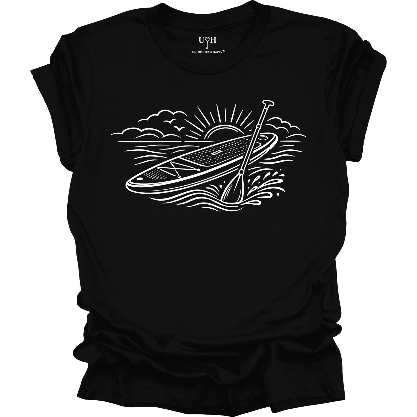 Black t-shirt featuring white line art of a stand up paddle board with paddle on water at sunrise, worn by model, ocean and beach lifestyle design