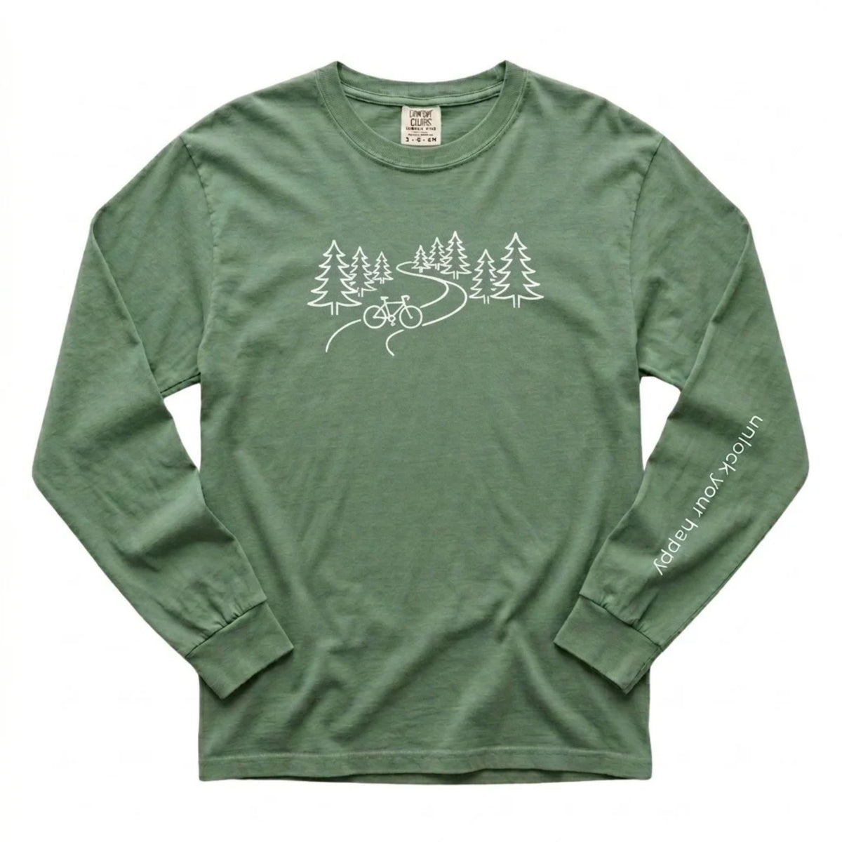 A long-sleeve crewneck t-shirt in a light green color, featuring a white line art graphic of pine trees, a winding road, and a bicycle on the chest, with 'Unlock Your Happy' printed vertically in white on the left sleeve.