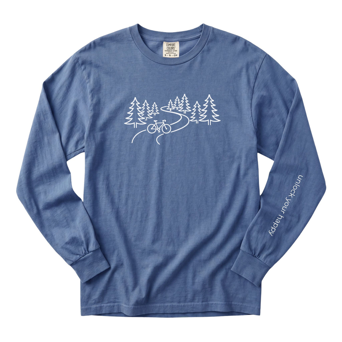 A long-sleeve crewneck t-shirt in a blue jean color, featuring a white line art graphic of pine trees, a winding road, and a bicycle on the chest, with 'Unlock Your Happy' printed vertically in white on the left sleeve.