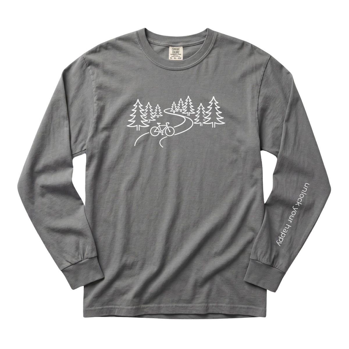 A long-sleeve crewneck t-shirt in a grey color, featuring a white line art graphic of pine trees, a winding road, and a bicycle on the chest, with 'Unlock Your Happy' printed vertically in white on the left sleeve.