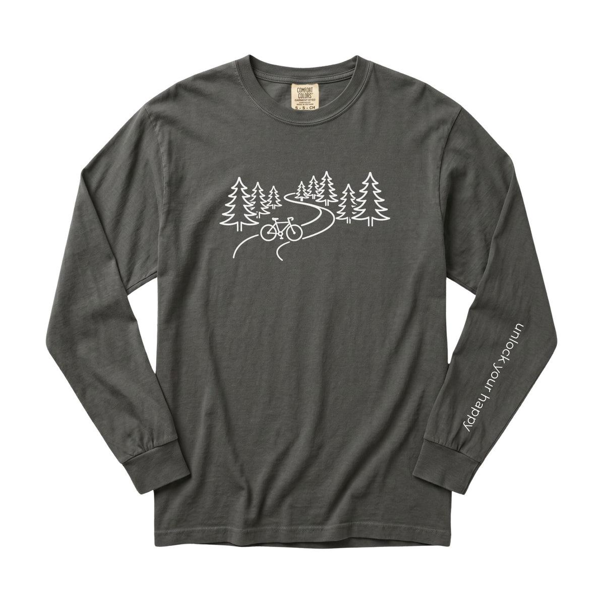 A long-sleeve crewneck t-shirt in a pepper grey color, featuring a white line art graphic of pine trees, a winding road, and a bicycle on the chest, with 'Unlock Your Happy' printed vertically in white on the left sleeve.