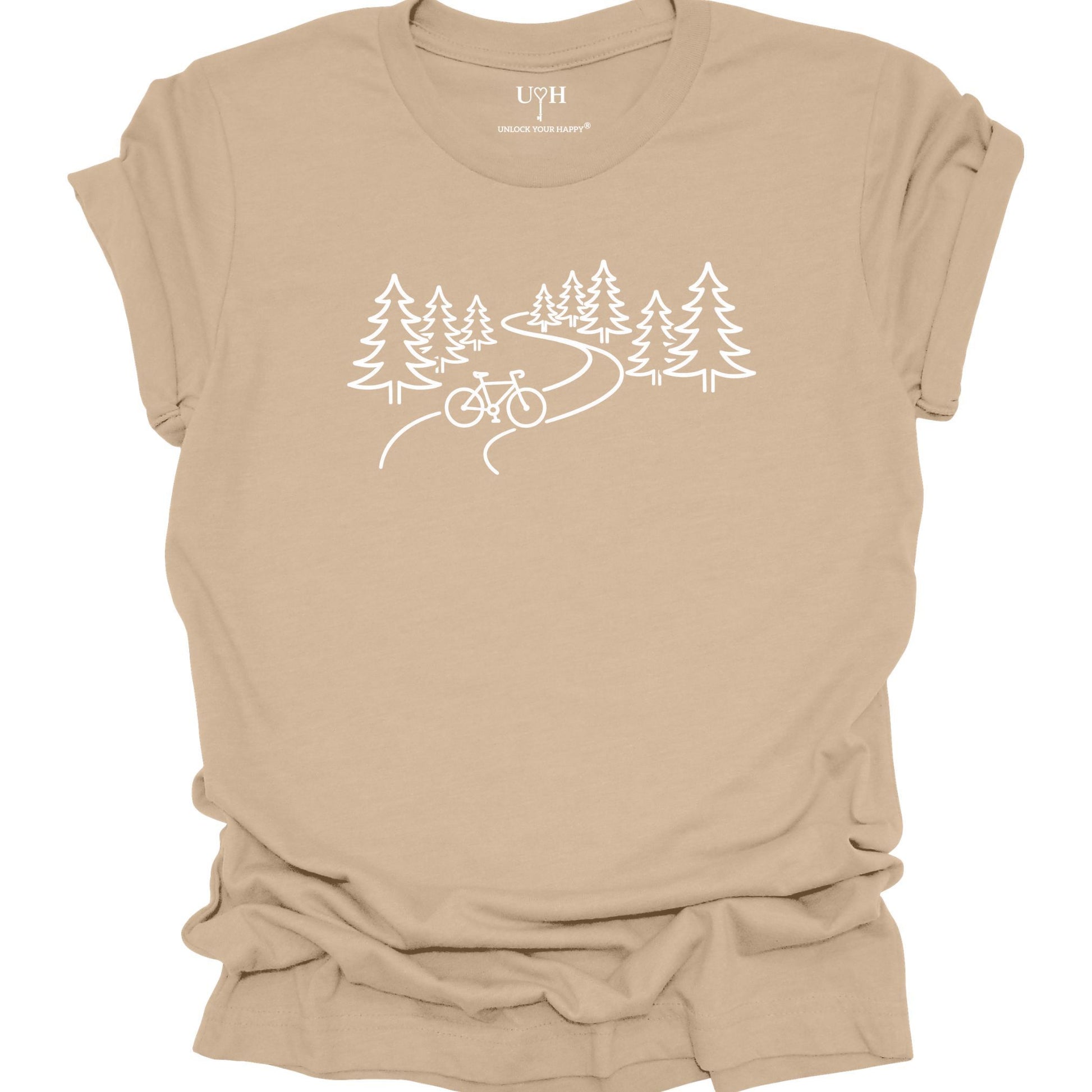 nature biking graphic tan t-shirt with minimalist forest trail and bicycle design, featuring “unlock your happy” text on sleeve
