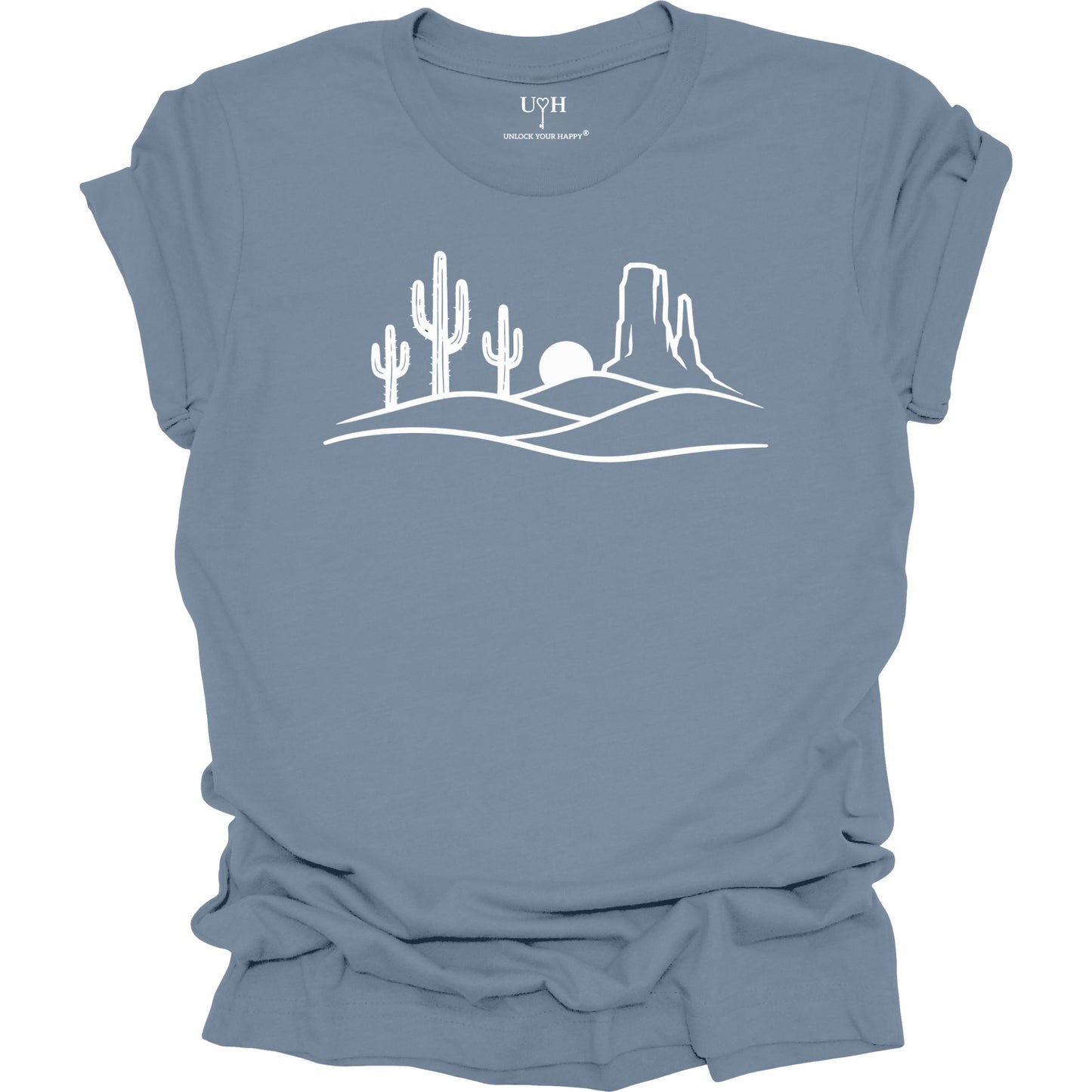 Blue t-shirt with white desert landscape graphic on a white background