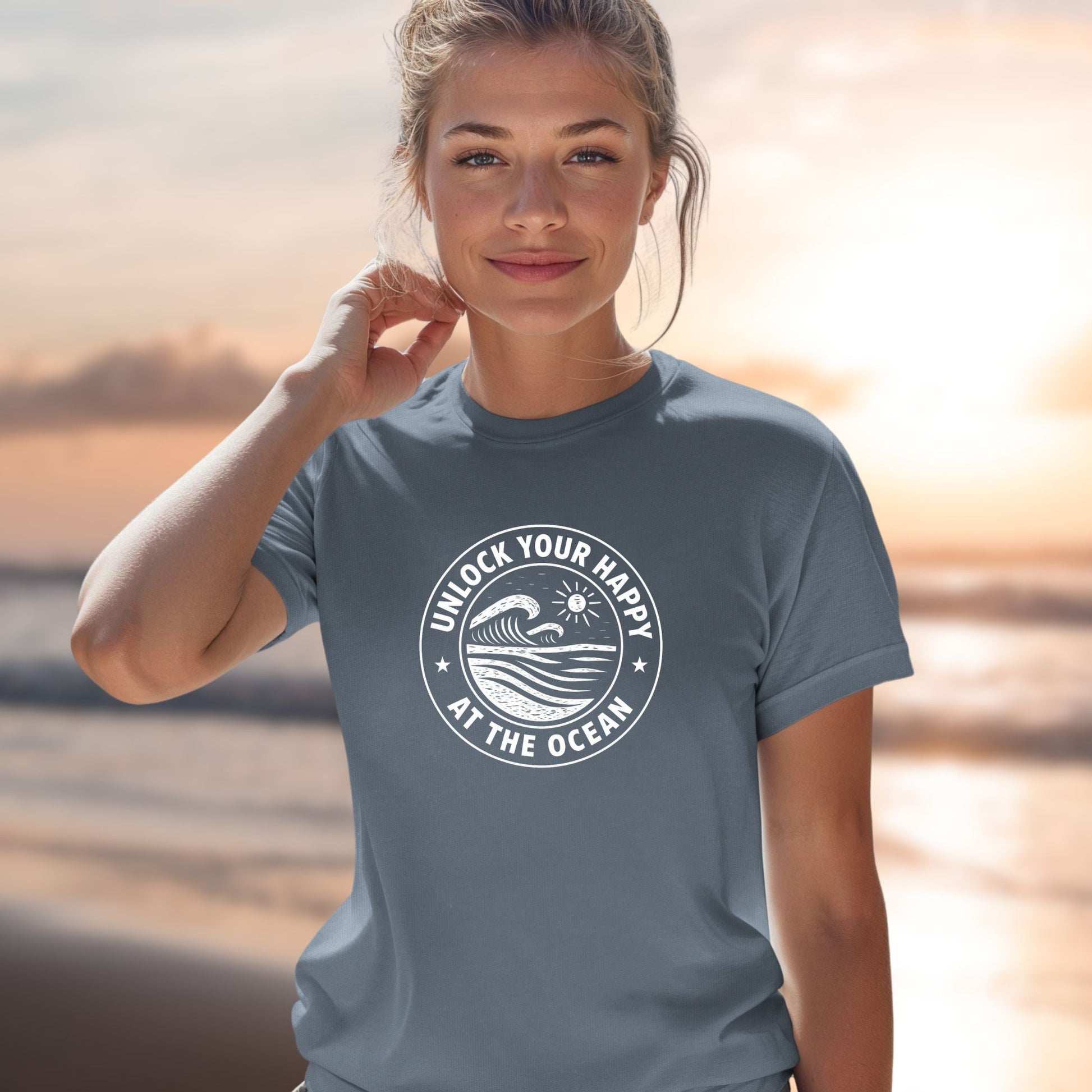 Woman wearing a t-shirt with a Person wearing a t-shirt with 'Unlock Your Happy at the Ocean' design and  text on a blurred beach background