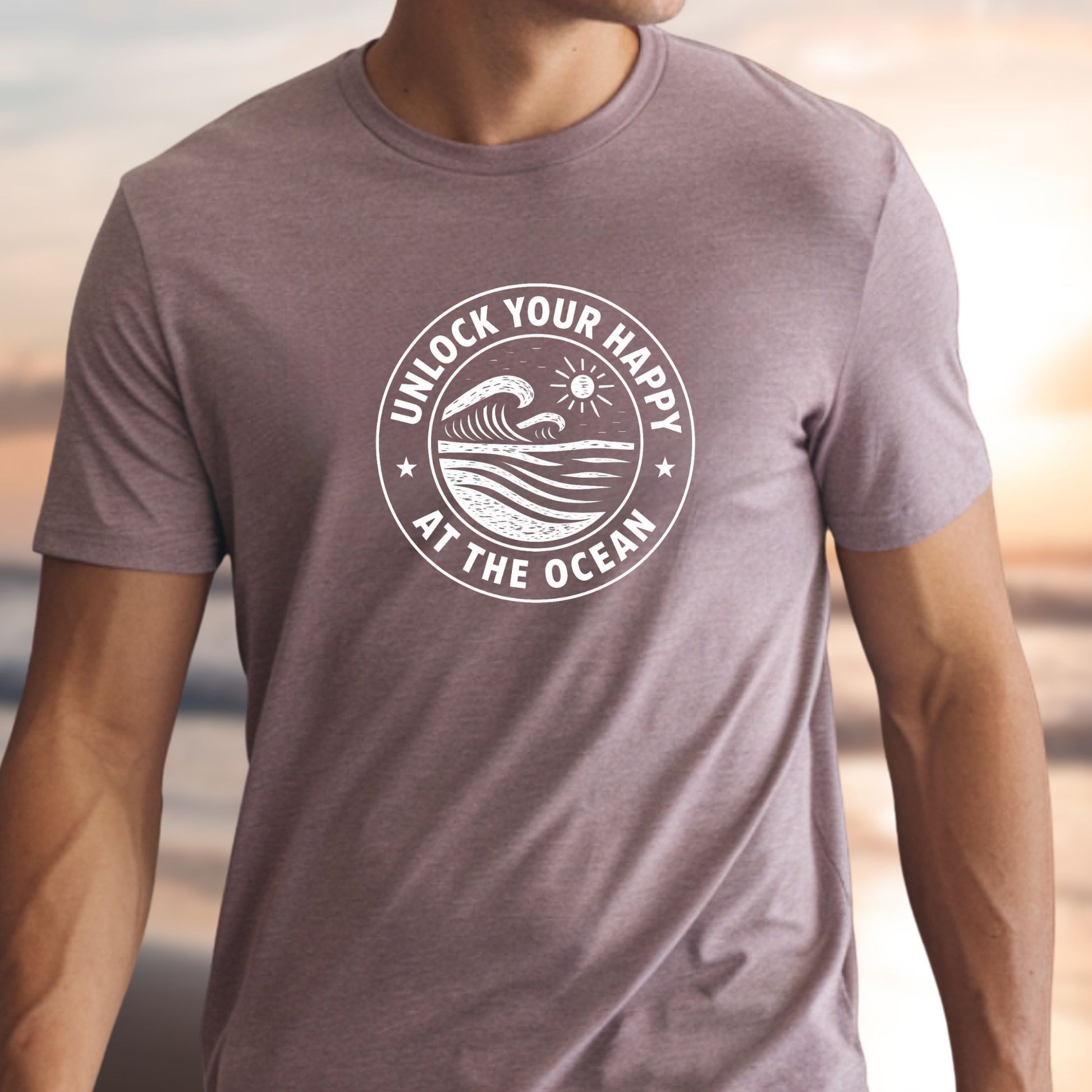 Person wearing a t-shirt with 'Unlock Your Happy at the Ocean' design.