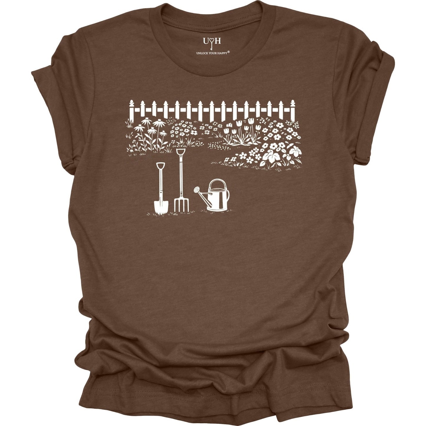 White gardening graphic on a brown t-shirt featuring garden tools and flower garden illustration with nature-inspired design 