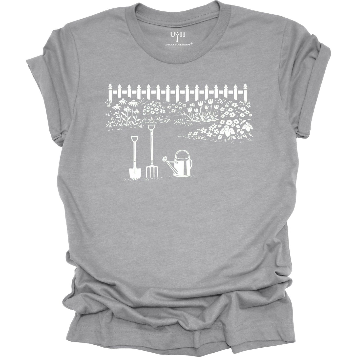 White gardening graphic on a gray t-shirt featuring garden tools and flower garden illustration with nature-inspired design 