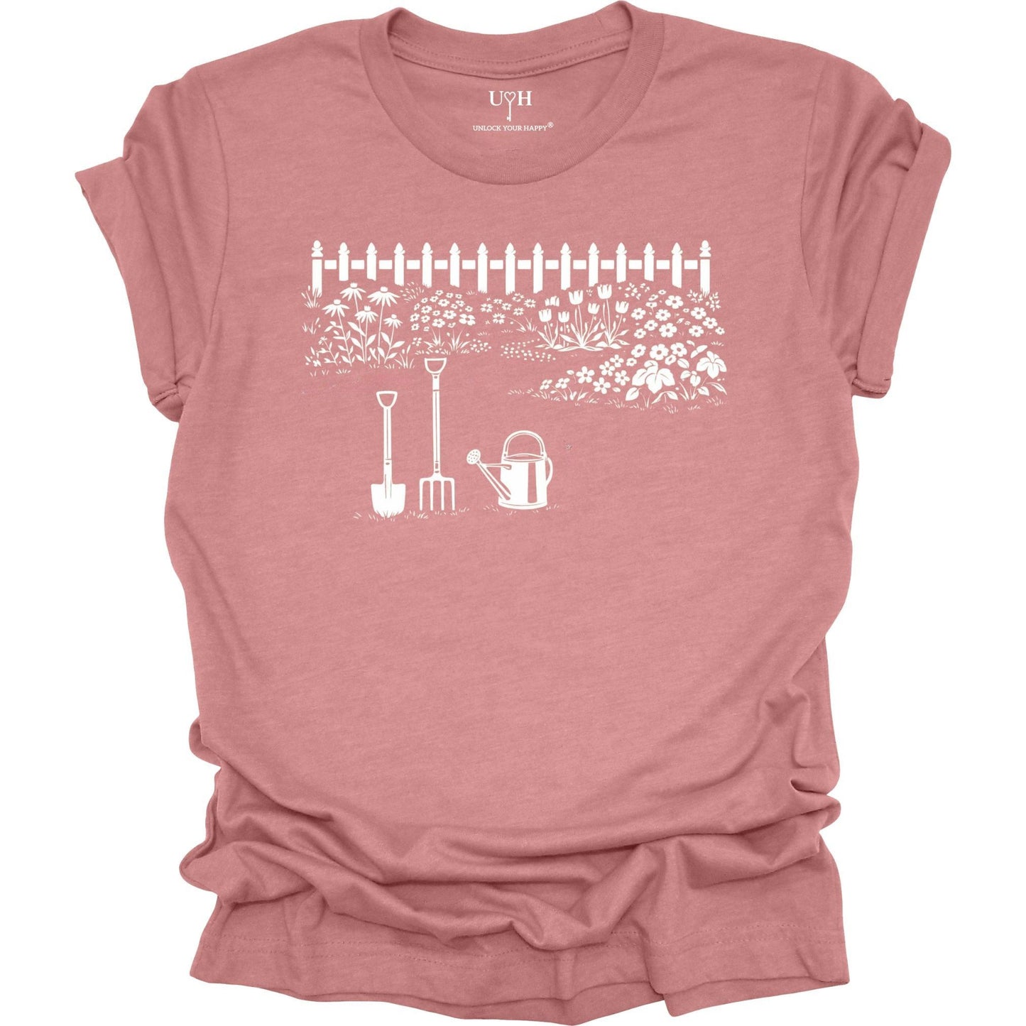 White gardening graphic on a mauve t-shirt featuring garden tools and flower garden illustration with nature-inspired design 