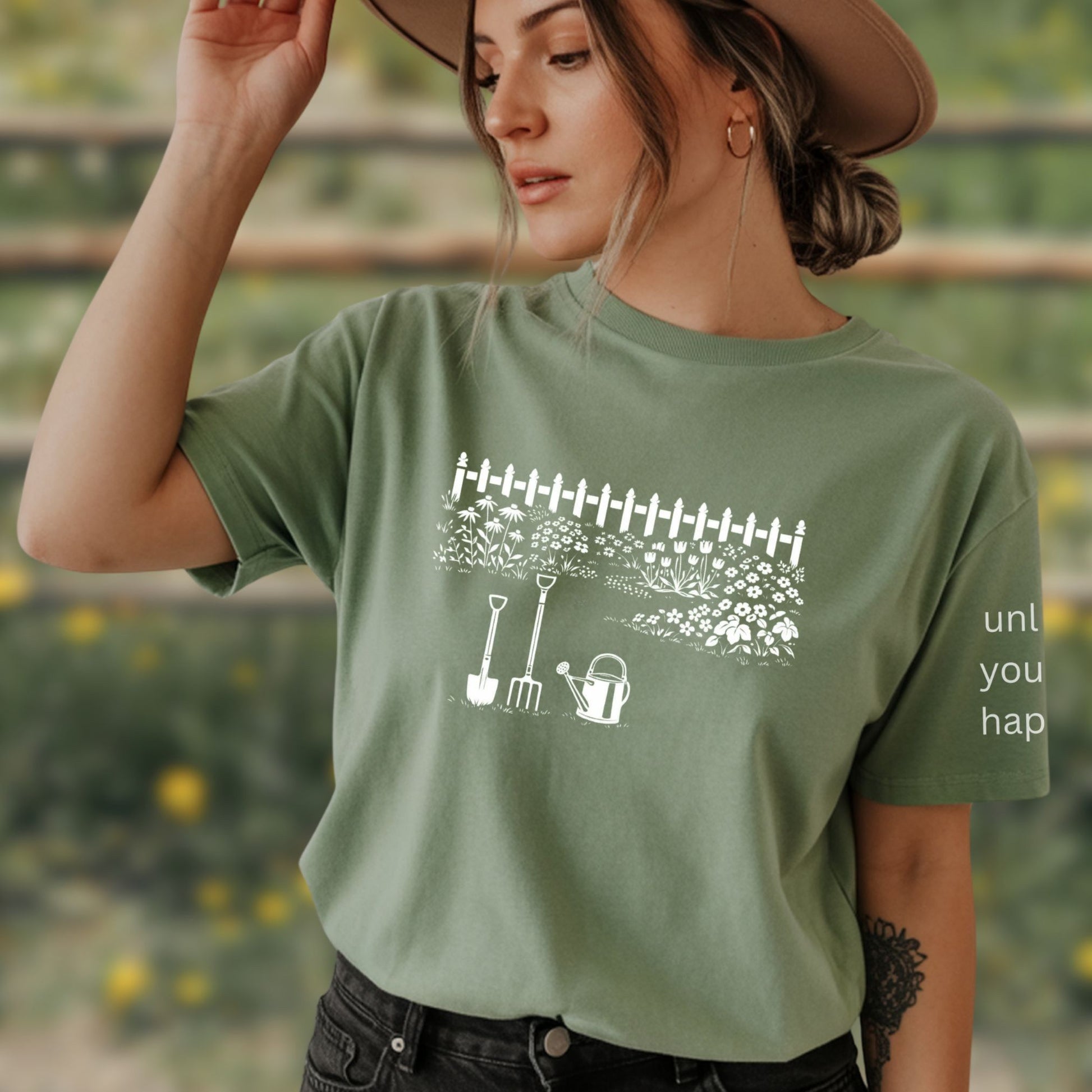 Female wearing a white graphic gardening design sage-green  t-shirt with unlock your happy text on sleeve standing outdoors.