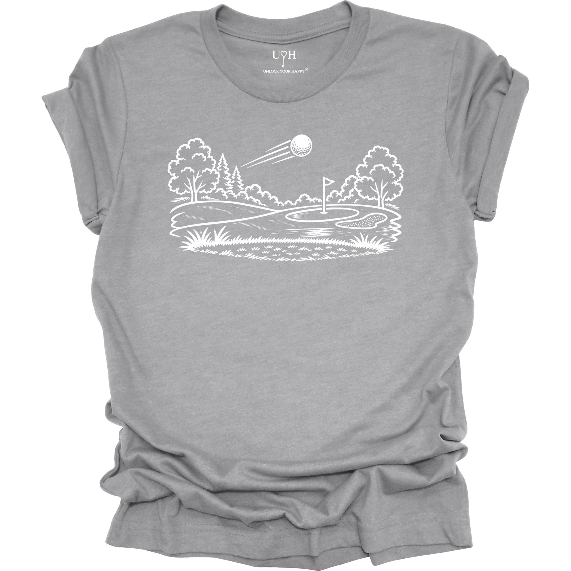 Minimalist golf course graphic t-shirt with line art design of golf ball and green on soft unisex gray
 tee