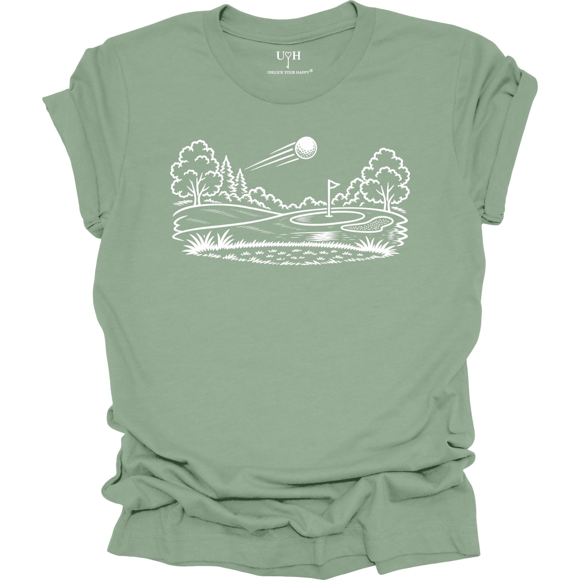 Minimalist golf course graphic t-shirt with line art design of golf ball and green on soft unisex sage green tee