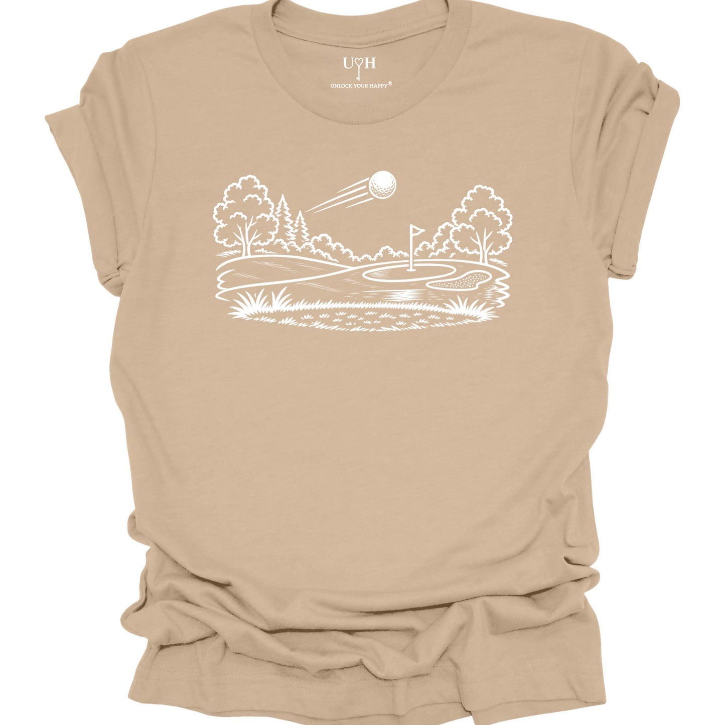 Minimalist golf course graphic t-shirt with line art design of golf ball and green on soft unisex tan tee