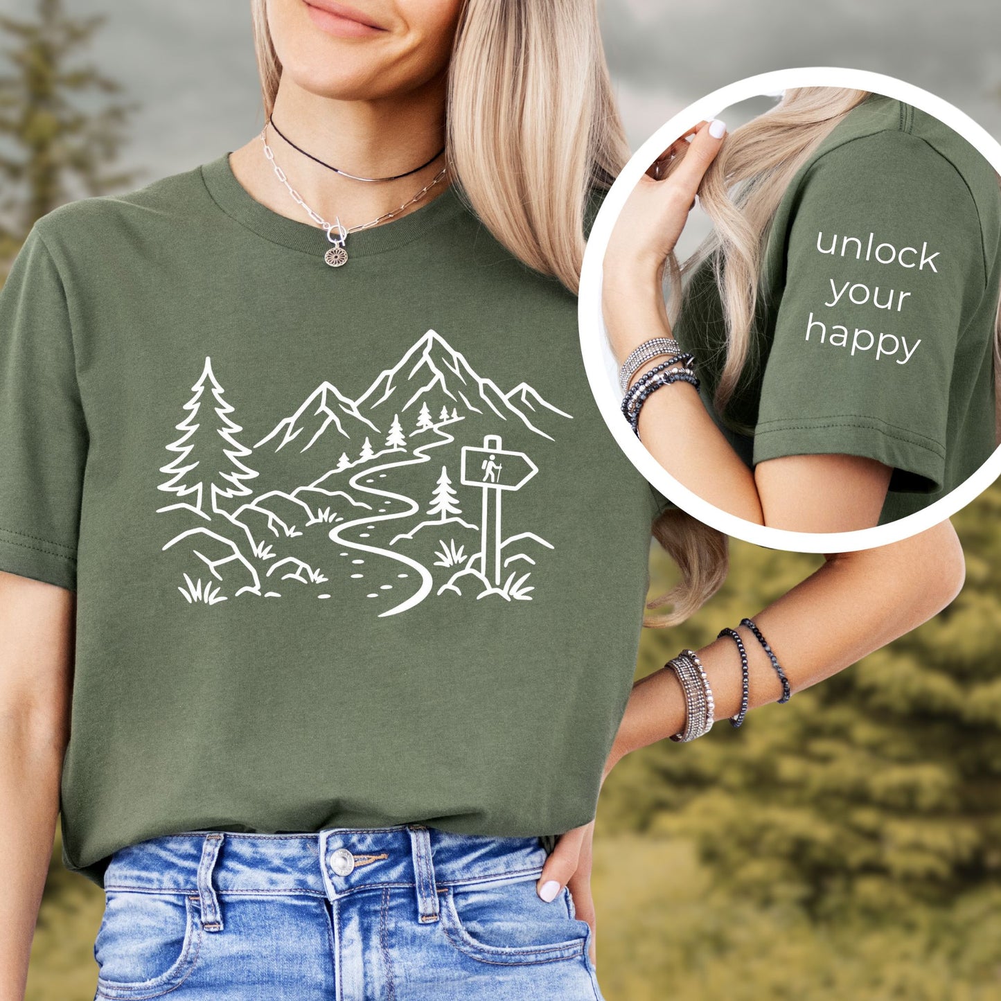 Person wearing a green t-shirt with a mountain design and 'unlock your happy' text on sleeve.