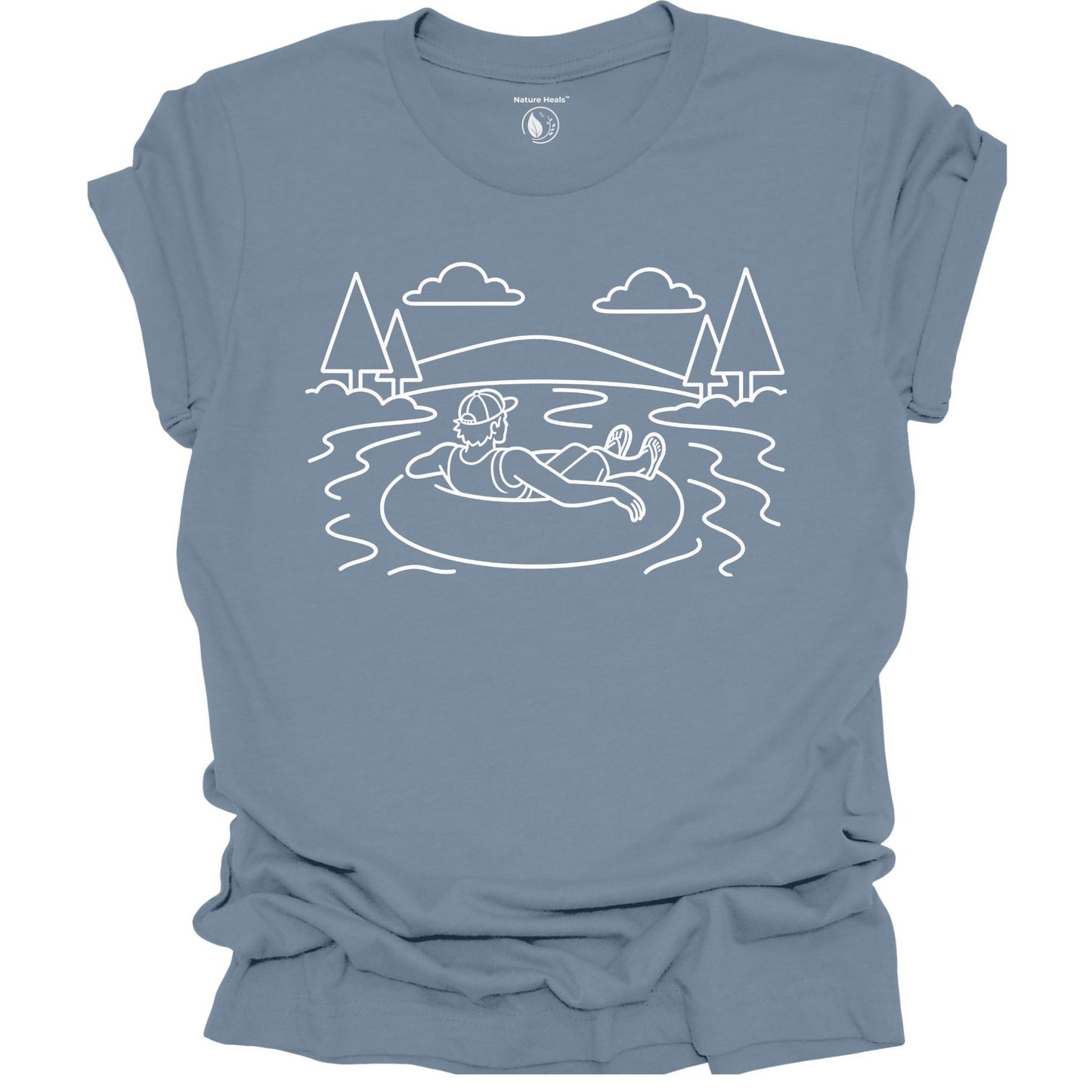Blue t-shirt with white line art of a person on an inner tube in a lake, surrounded by trees and mountains.