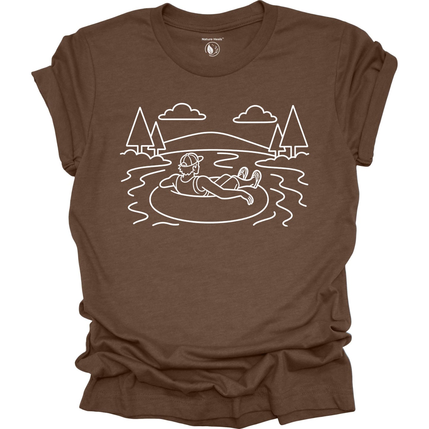 Brown t-shirt with white graphic of a person on an inner tube in a lake, surrounded by trees and mountains.