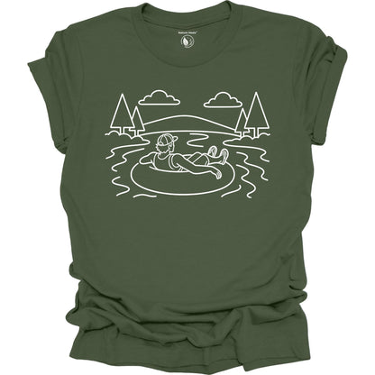 Green t-shirt with white line art of a person on an inner tube in a lake, surrounded by trees and mountains.