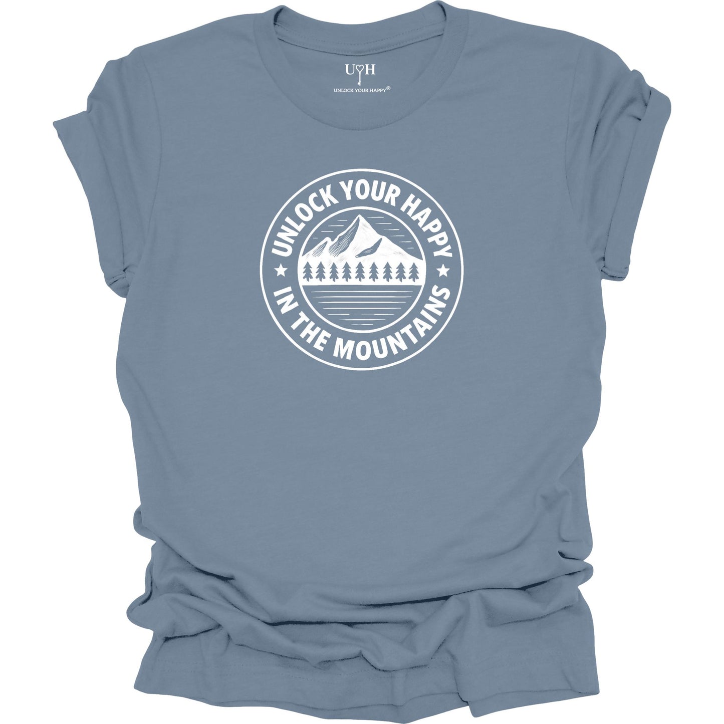 Blue unisex graphic t-shirt featuring a circular mountain and pine tree design with the text “Unlock Your Happy in the Mountains”.