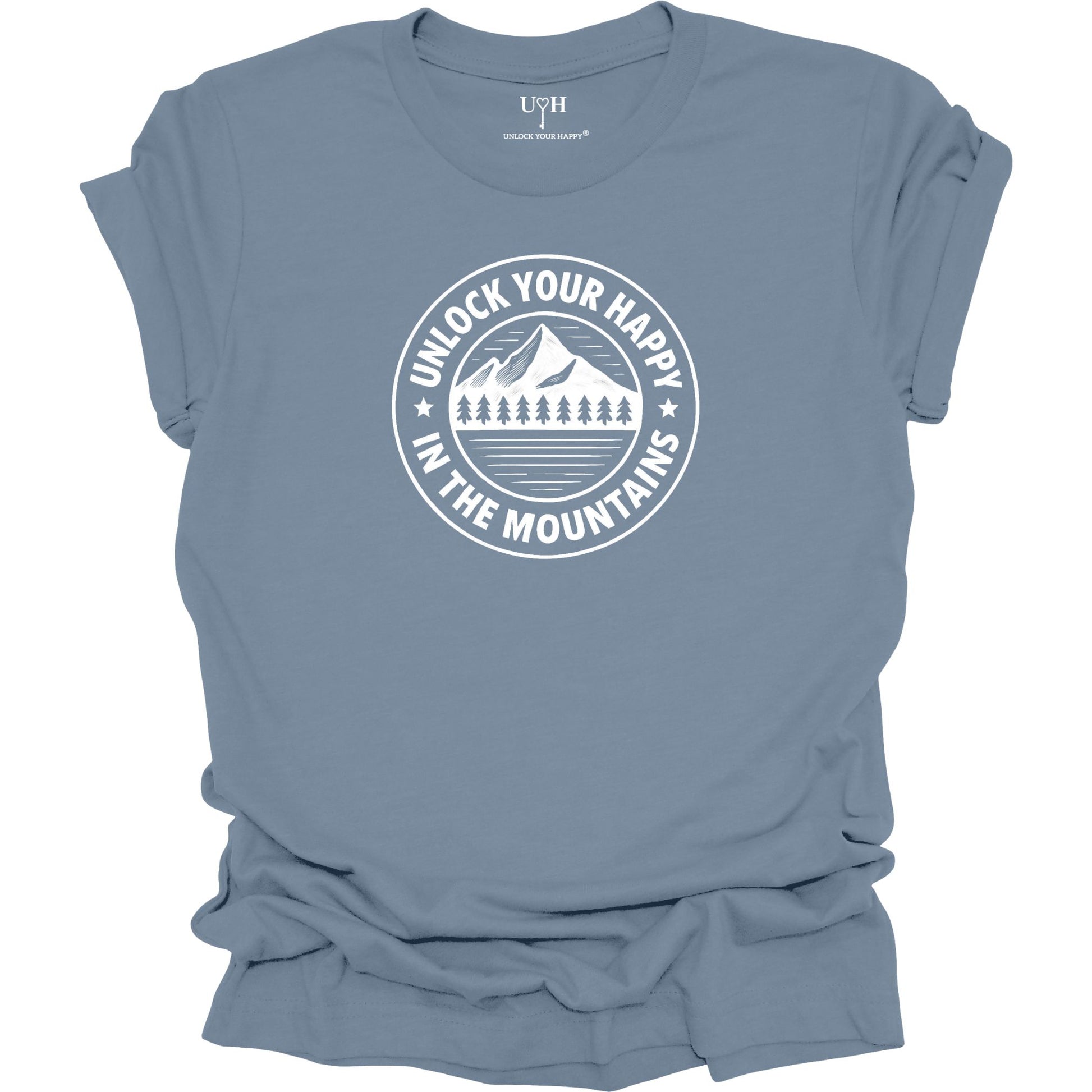 Blue unisex graphic t-shirt featuring a circular mountain and pine tree design with the text “Unlock Your Happy in the Mountains”.