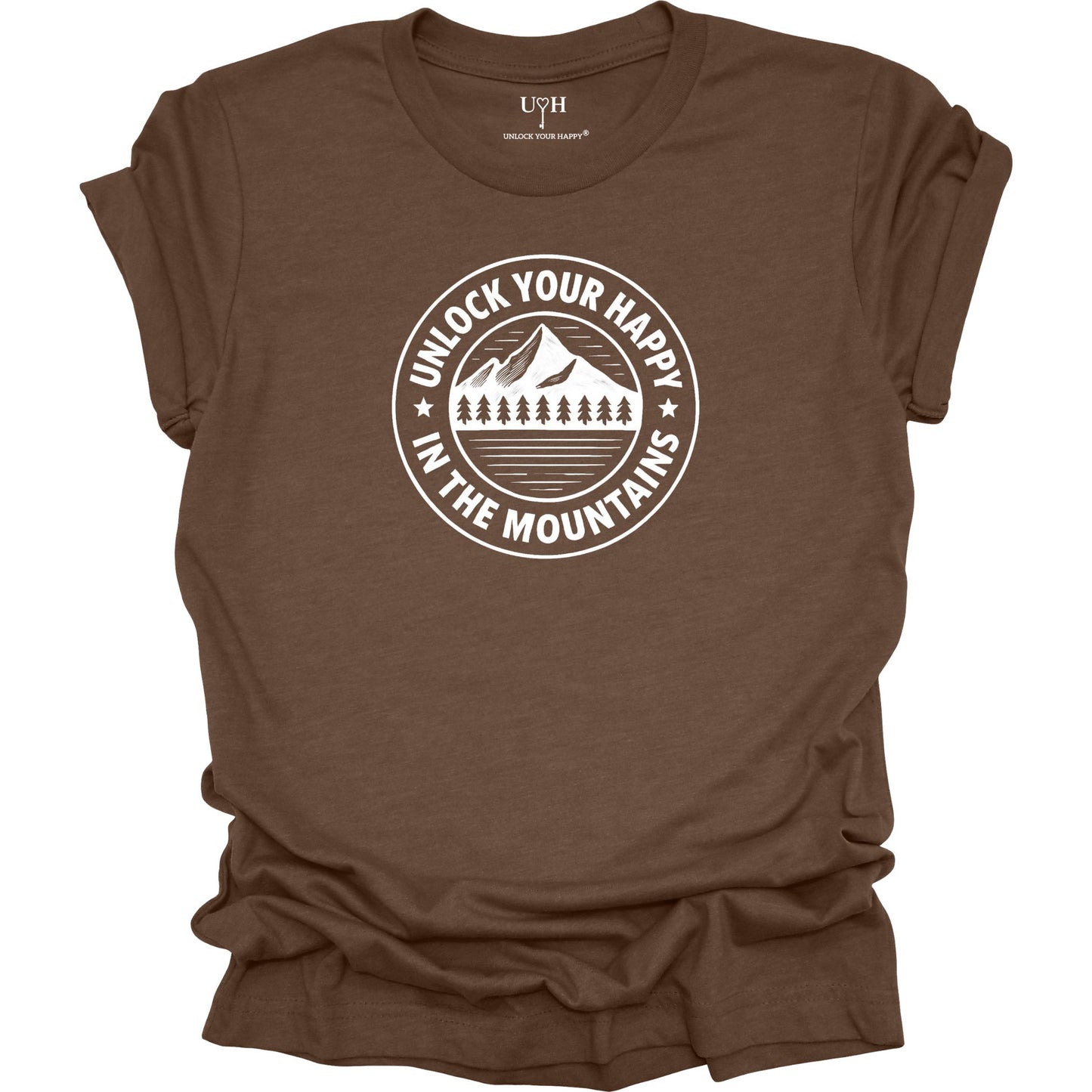 Brown unisex graphic t-shirt featuring a circular mountain and pine tree design with the text “Unlock Your Happy in the Mountains”.