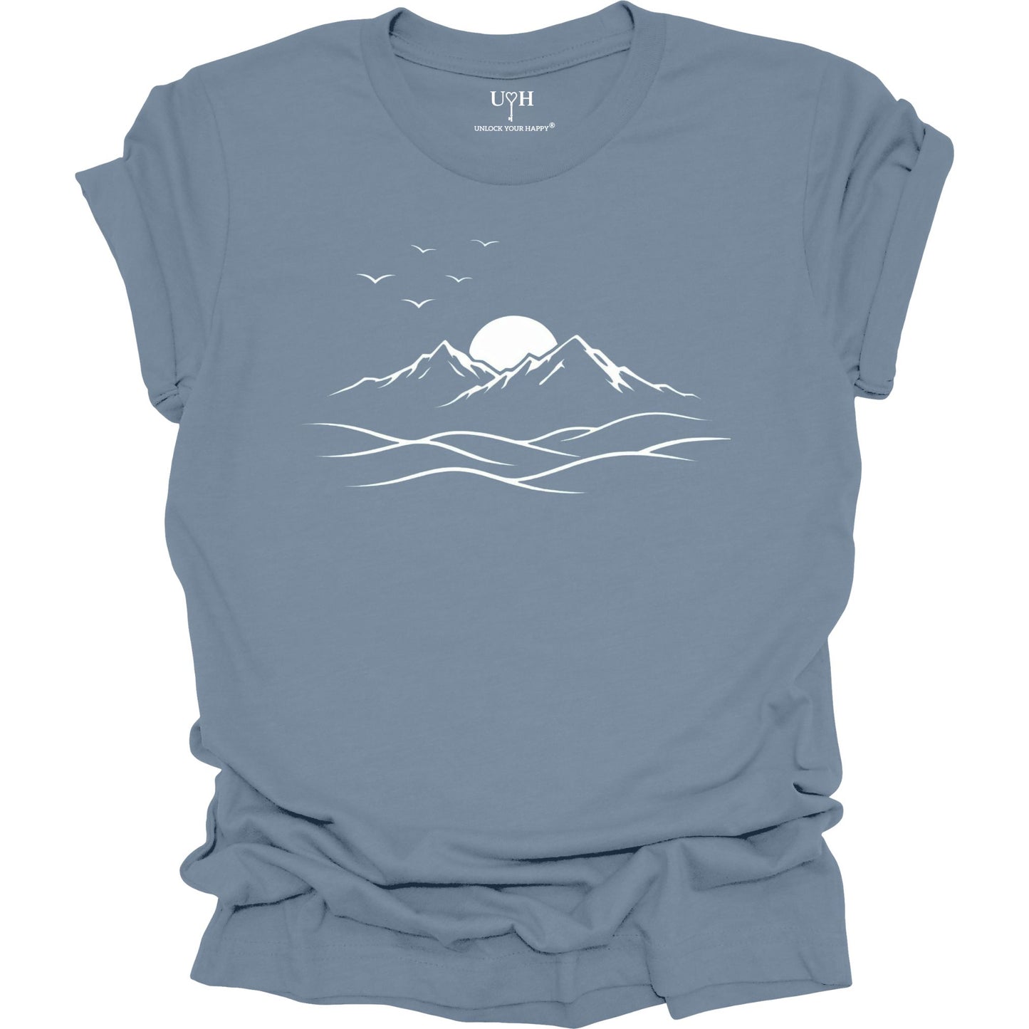 Blue t-shirt with mountain and sun design on a white background