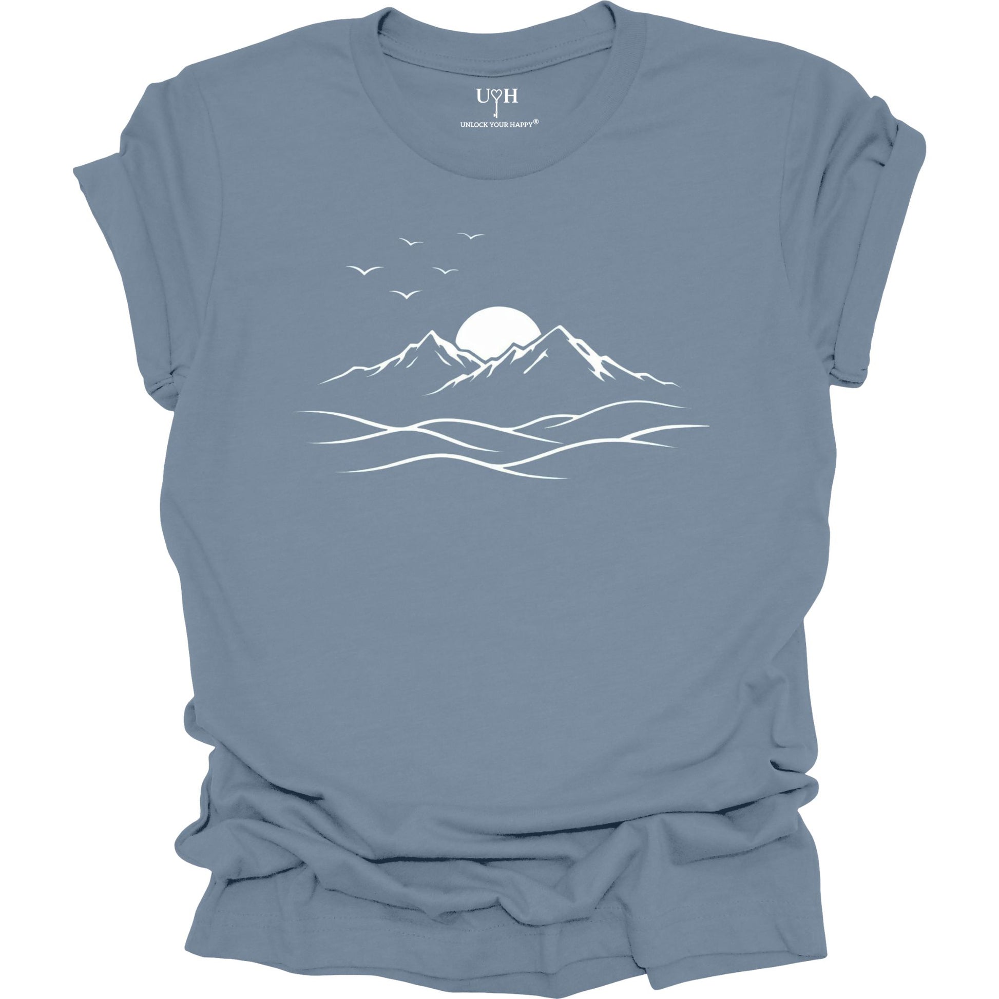 Blue t-shirt with mountain and sun design on a white background