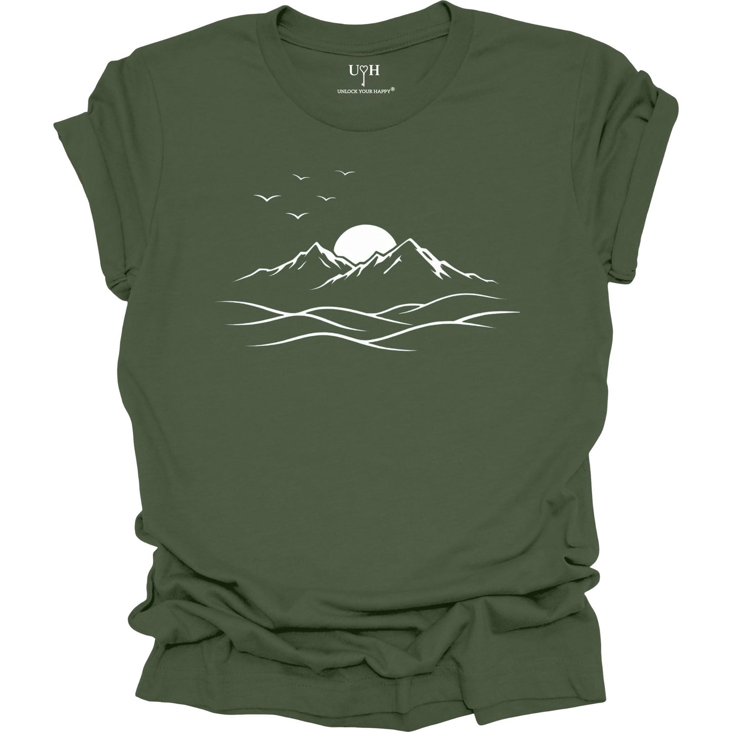 Green t-shirt with mountain and sun design on a white background