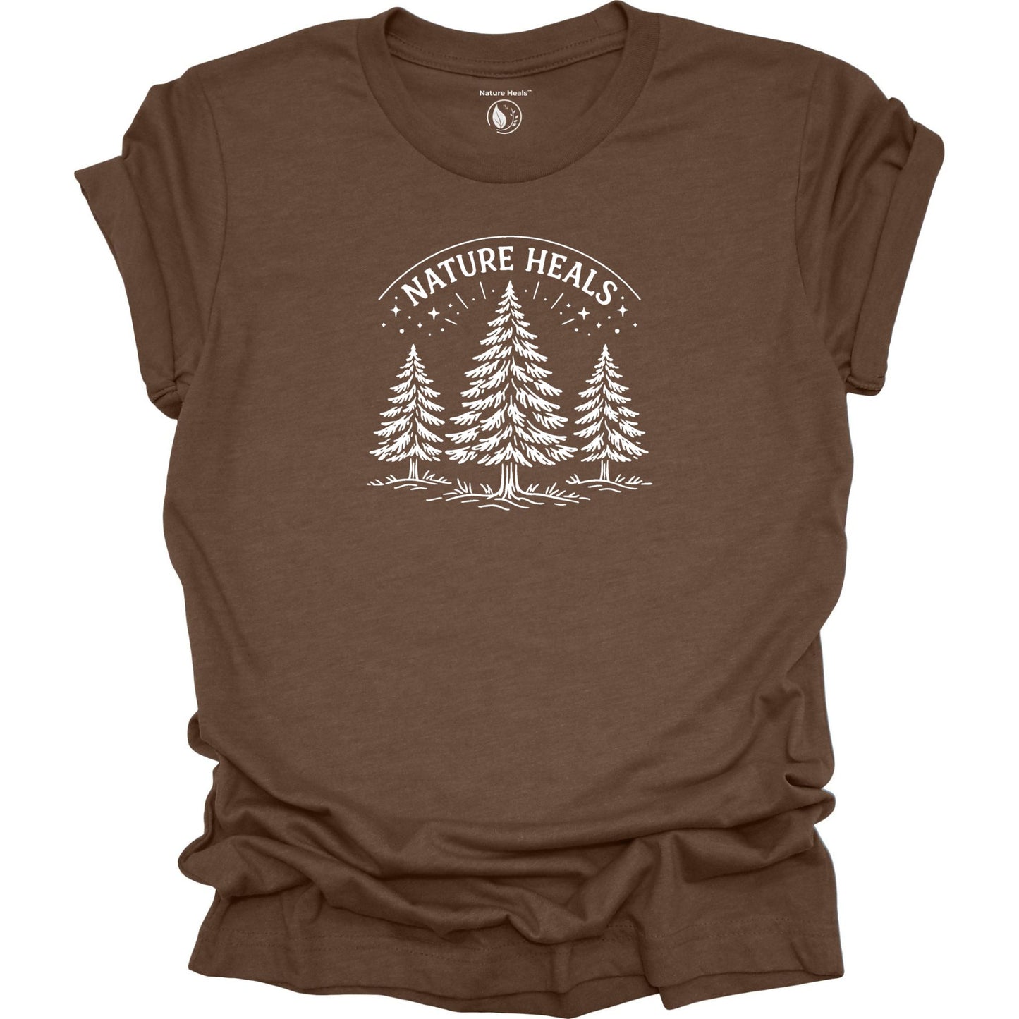 Minimalist Nature Heals t-shirt with pine tree graphic on brown fabric, designed for nature lovers, wellness, and outdoor lifestyle
