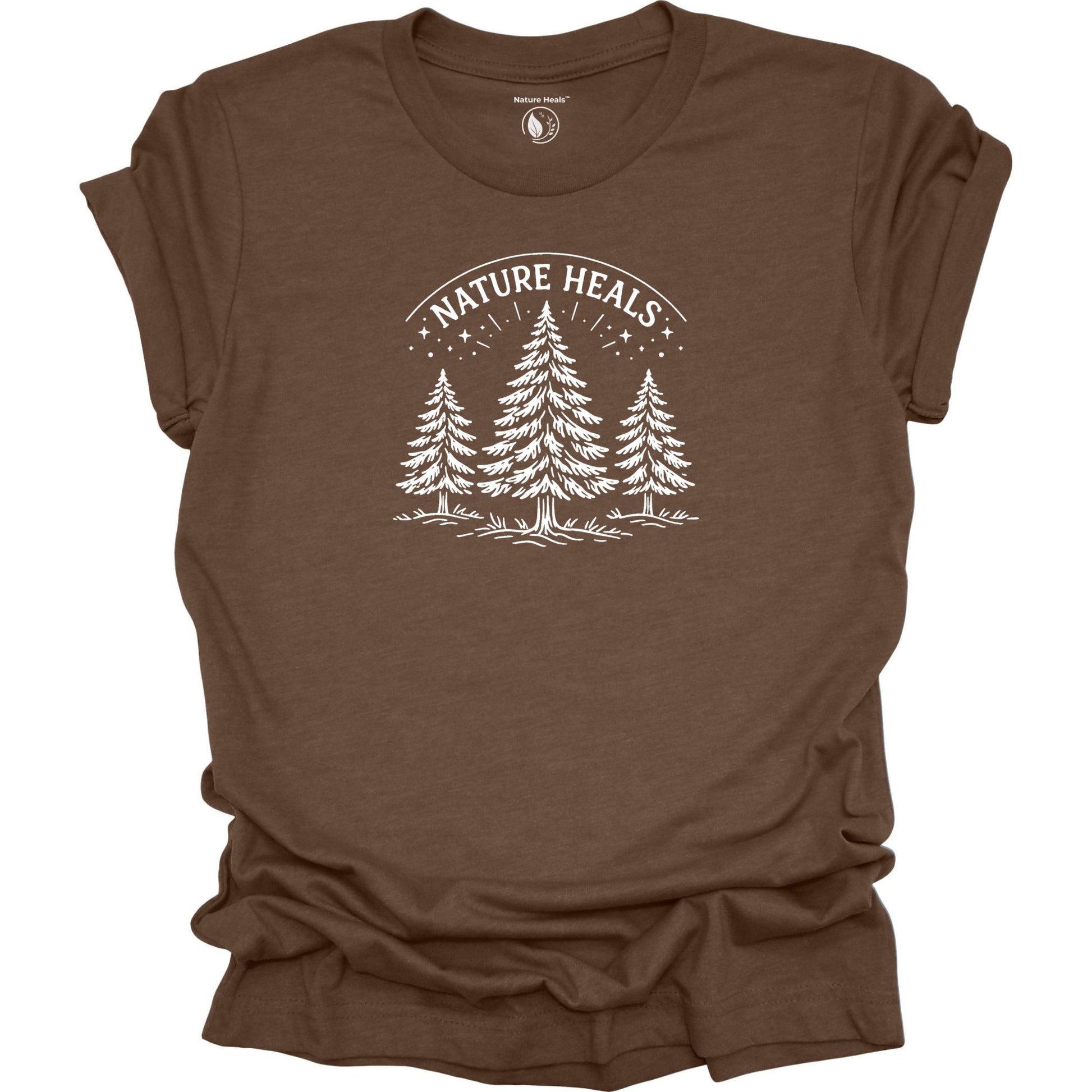 Minimalist Nature Heals t-shirt with pine tree graphic on brown fabric, designed for nature lovers, wellness, and outdoor lifestyle