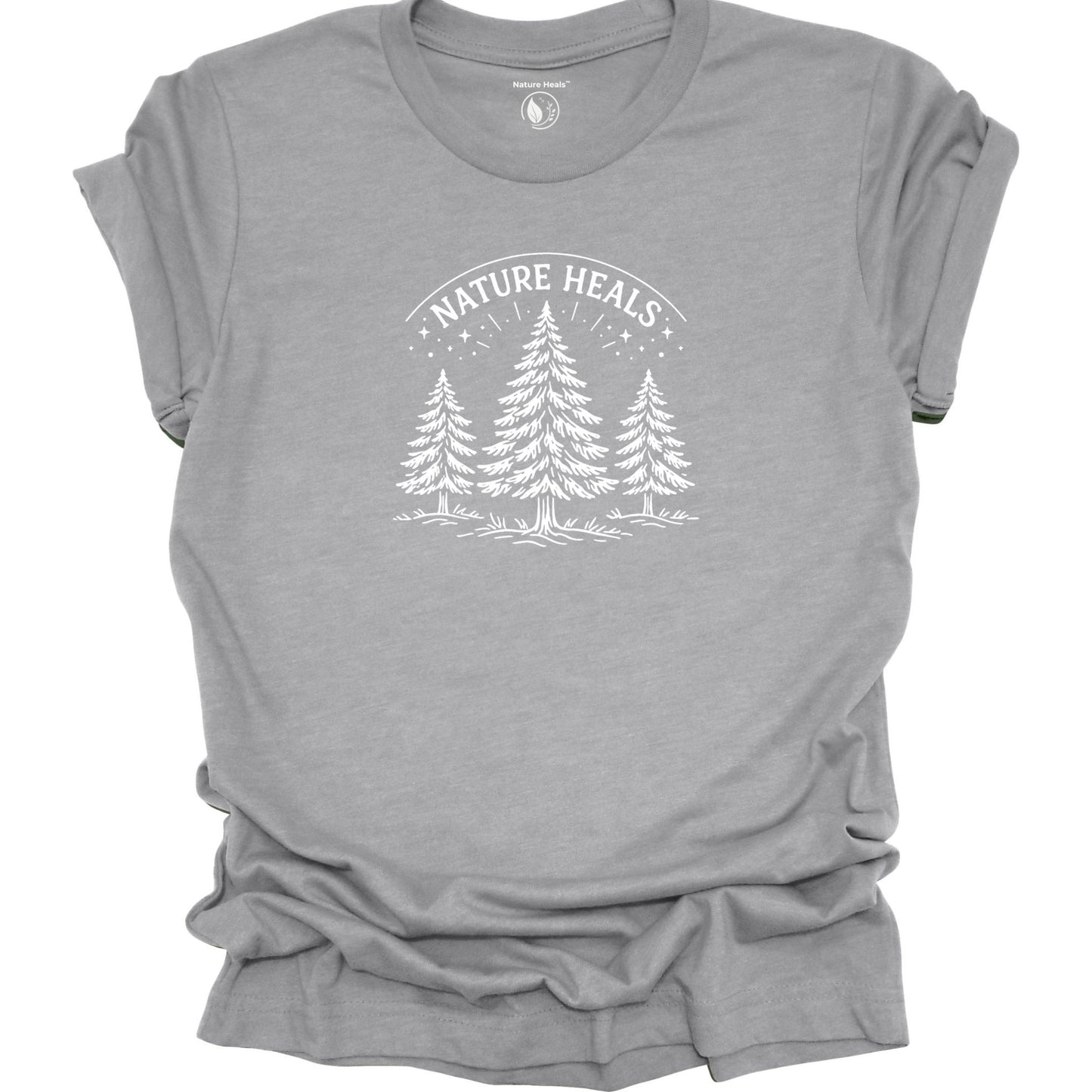 Minimalist Nature Heals t-shirt with pine tree graphic on gray fabric, designed for nature lovers, wellness, and outdoor lifestyle