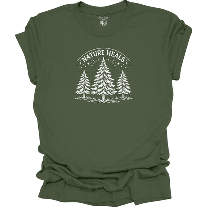 Minimalist Nature Heals t-shirt with pine tree graphic on  green fabric, designed for nature lovers, wellness, and outdoor lifestyle