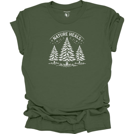 Minimalist Nature Heals t-shirt with pine tree graphic on  green fabric, designed for nature lovers, wellness, and outdoor lifestyle