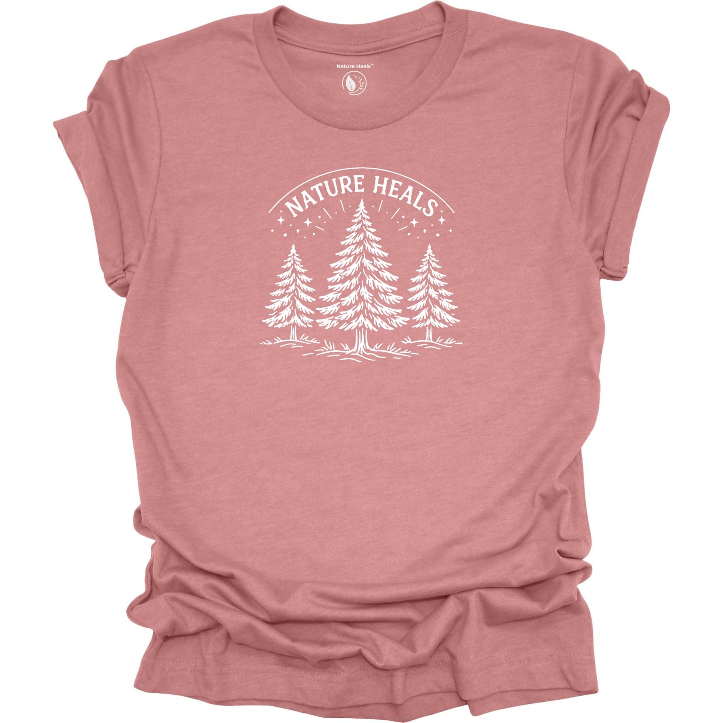 Minimalist Nature Heals t-shirt with pine tree graphic on mauve fabric, designed for nature lovers, wellness, and outdoor lifestyle
