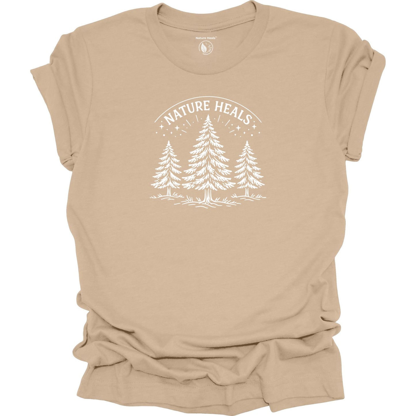 Minimalist Nature Heals t-shirt with pine tree graphic on tan  fabric, designed for nature lovers, wellness, and outdoor lifestyle