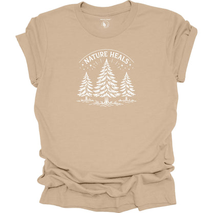Minimalist Nature Heals t-shirt with pine tree graphic on tan  fabric, designed for nature lovers, wellness, and outdoor lifestyle