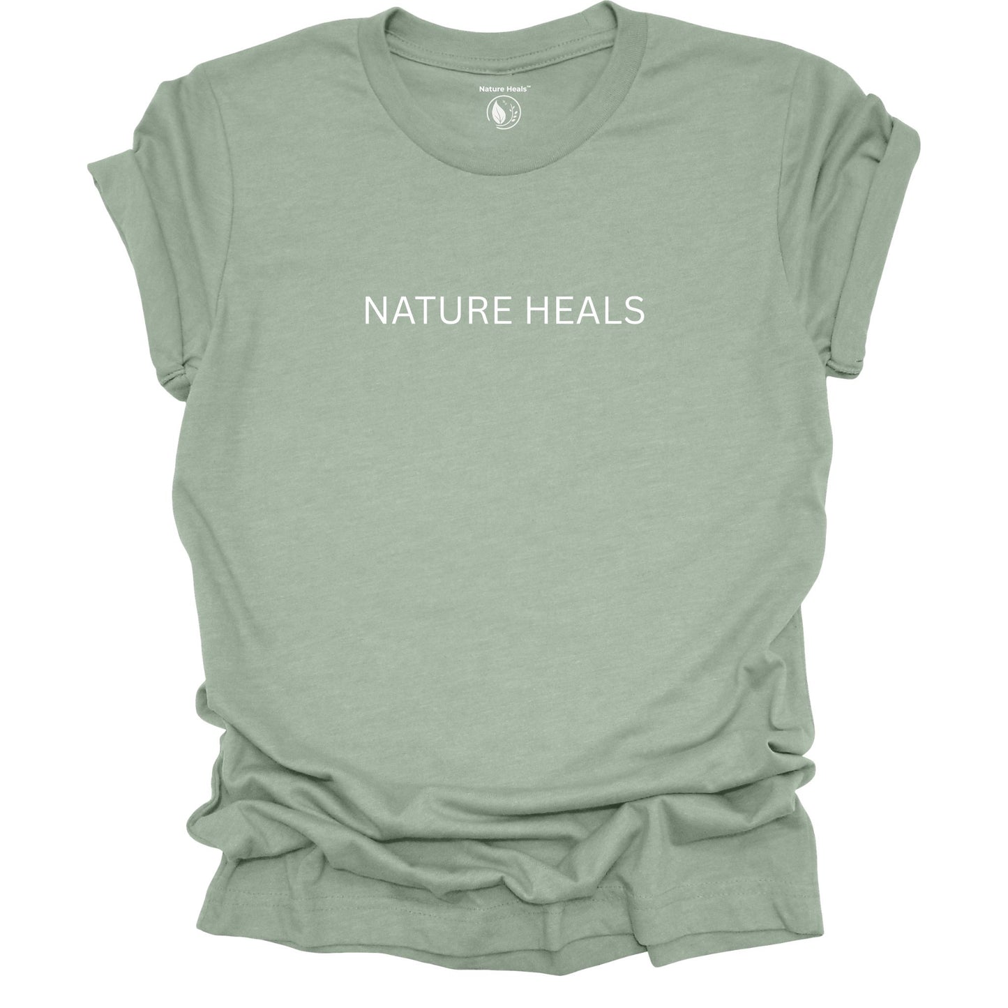 Sage green t-shirt with 'NATURE HEALS' text on a white background