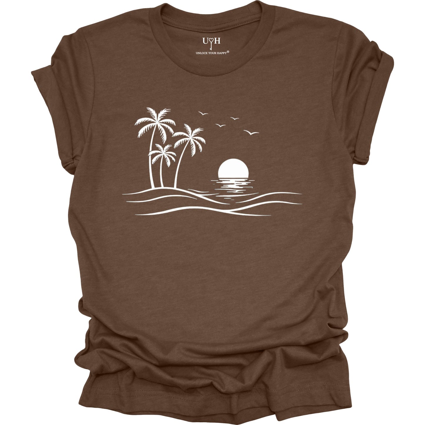 Brown t-shirt with a white beach scene graphic on a white background