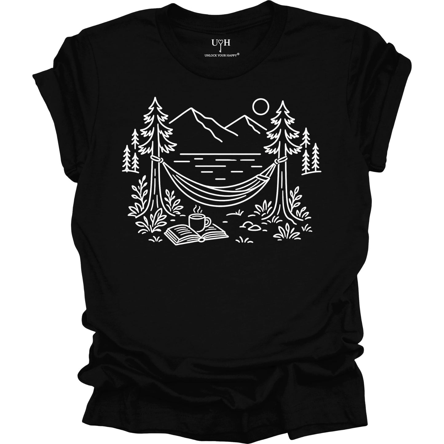 Black unisex t-shirt with a white line art hammock scene featuring mountains, trees, a lake, coffee cup, and open book, plus ‘unlock your happy’ on the sleeve.